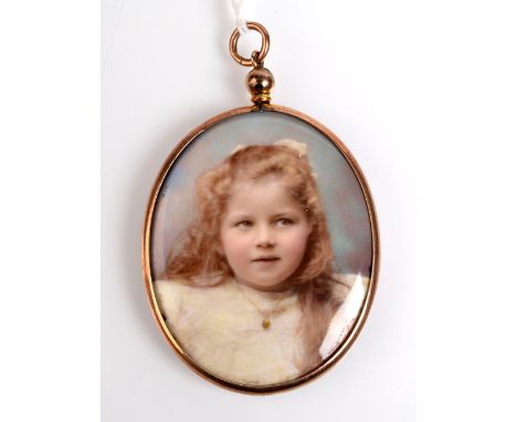A miniature portrait of a child in 9ct. gold mount with blue enamel back. 