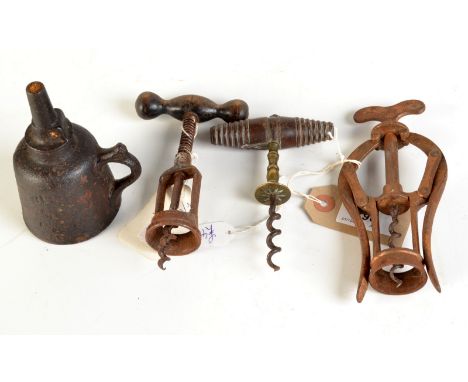 A Heeley's patent double lever corkscrew and two other corkscrews together with a Well's cast iron oil lamp.