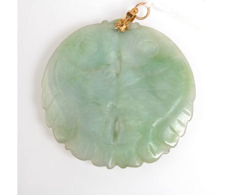 A jade pendent carved and pierced with two confronting fish.