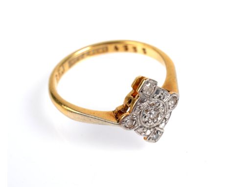 An 18ct. gold and platinum cruciform diamond cluster ring.