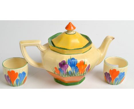 A Clarice Cliff crocus pattern teapot, spout chipped and a pair of matching egg cups. Condition Report: The spout of the teap