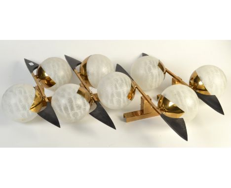 A set of four modernist wall lamps, each with a pair of white-combed, glass globes, mounted between black plastic blade finia