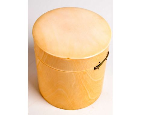 A cylindrical ivory snuff box with hinged lid.