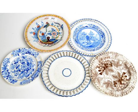 An 18th century delft plate with coloured decoration of a parrot amongst foliage, a blue and white plate and three pearlware 