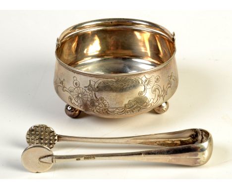 A COLLECTION OF RUSSIAN SILVER

A Russian silver swing handled sugar bowl with leaf, scale and scroll engraving.  Together wi