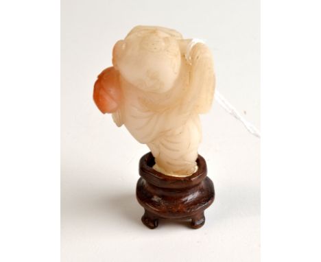 THE LESLIE DAVIE COLLECTION OF JADE

A Tang style white and red tinted figure, possibly late 18th or 19th century, of a stand