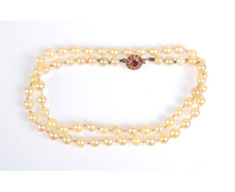 A "pearl" necklace with ruby set gold clasp.