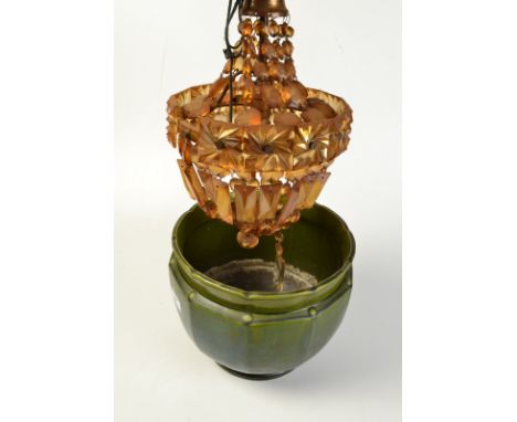An amber glass chandelier light fitting and a green glaze jardiniere. 