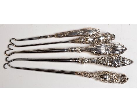 An Art Nouveau silver handled button hook, together with four other button hooks.