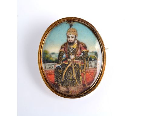 A fine Indian gold mounted miniature portrait of a Prince heightened with gold, 2.8 x 2.3cm.
