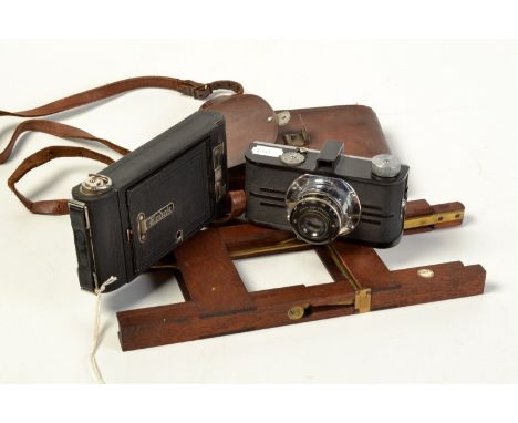 A 1930s' Argus Ilex black Bakelite and chrome camera numbered 2011, a folding camera and one other piece.