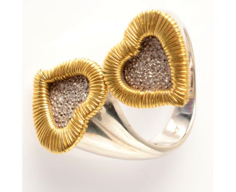 An 18ct. white and yellow gold contemporary crossover ring with yellow gold, diamond pave set, hearts.