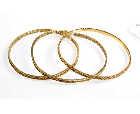 Two high purity gold filigree bangles and a third high purity gold bangle, 25.1 g.