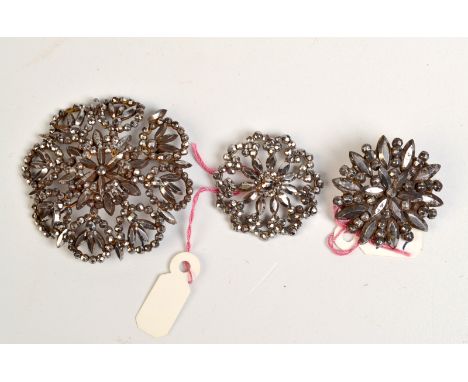 COLLECTION OF CUT STEEL

Two early Victorian cut-steel brooches in floral design, together with a similar button.