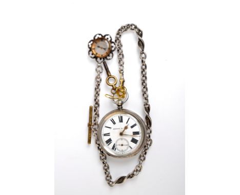 A silver cased, keyless, open face pocket watch by Kendal & Dent with silver chain and silver compass fob. 