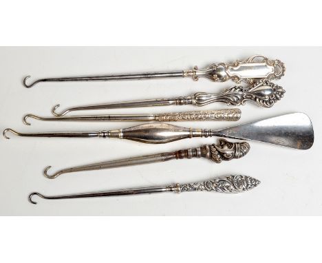 A silver mounted shoe horn/button hook, together with five silver handled button hooks. Condition Report: Mr Punch button hoo