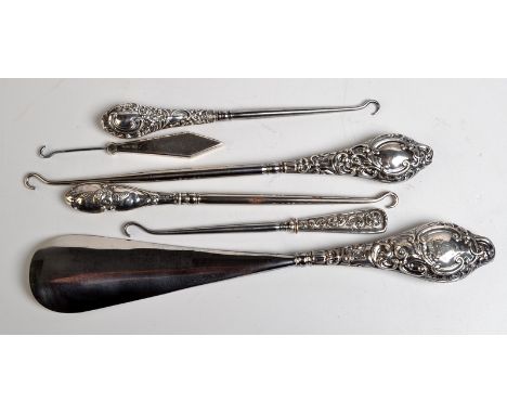 A silver handled shoe horn, together with five silver handled button hooks.
