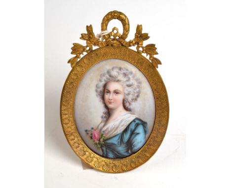 A miniature portrait on porcelain in gilt brass frame.