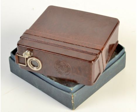 A brown bakelite "Midget Movie" cine camera projector.