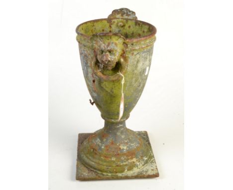 A cast iron vase with twin ring mask handles on square base. Condition Report: Height 44cm.
Rusty.