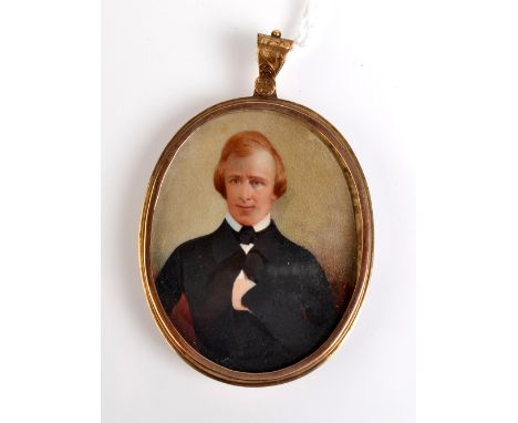 A portrait, a painted miniature of a young gentleman in engraved gold mount.