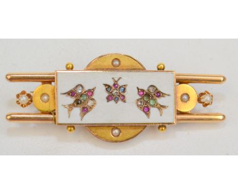 An Aesthetic Movement pearl set gold bar brooch with a white enamel panel containing two ruby and diamond-set birds in flight