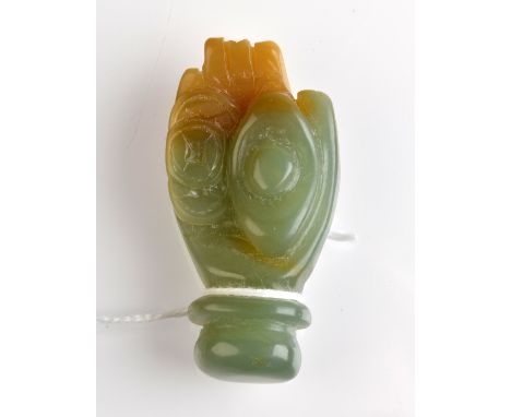 THE LESLIE DAVIE COLLECTION OF JADE

A green and russet jade carving of a human hand with ancient coins in its palm, 20th cen