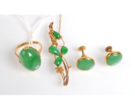 A Chinese gold jade set ring, a Chinese gold jade set bar brooch and a pair of gold jade earrings. 