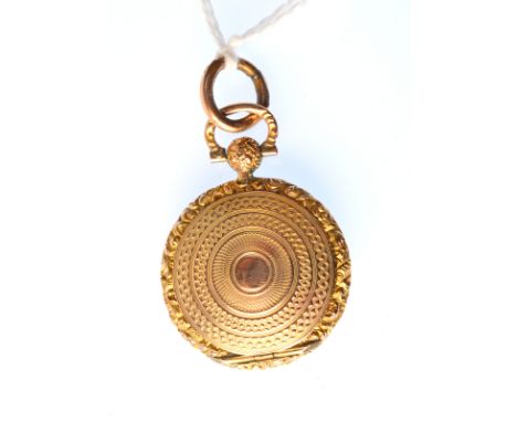 A gold locket by M.B. & Co, a gold architectural pendant and an oval gold brooch set with gold quartz.