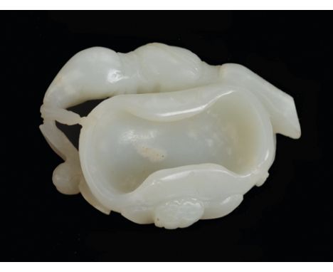 THE LESLIE DAVIE COLLECTION OF JADE

A white jade brush washer carved as a lotus plant, the bowl formed from a large leaf, su