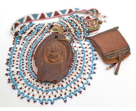 Two pieces of beadwork, possibly Native American, a carved wooden Native American cameo portrait and one other piece. 
