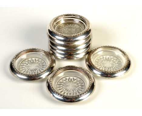 A set of eight modern American silver mounted glass coasters, each stamped 'Sterling'.