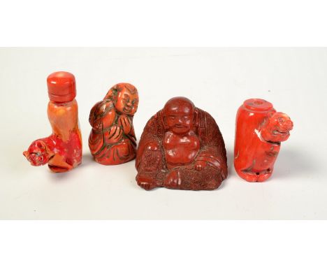 Two carved red coral snuff bottles, one other red coral carving and a lacquer Buddha.
