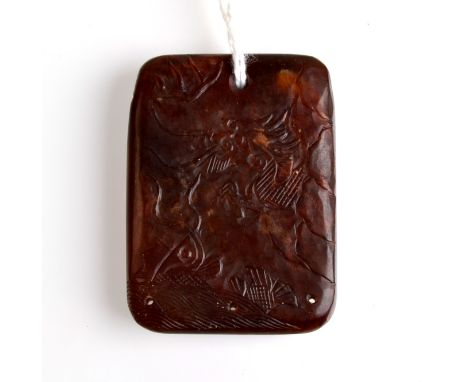 THE LESLIE DAVIE COLLECTION OF JADE

A rare, mottled, deep brown jade rectangular pendant carved in low relief with a tiger l
