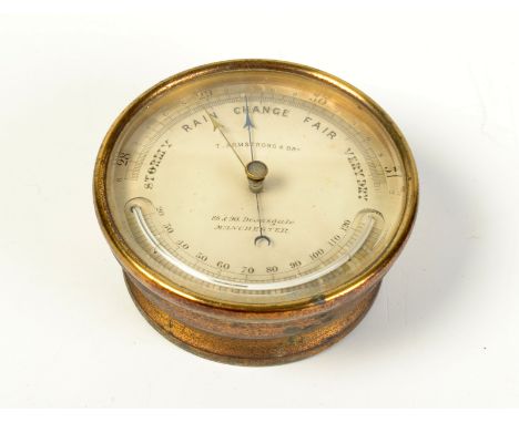 A circular brass aneroid barometer/thermometer by T Armstong & Bro Manchester, diameter 13.5cm.