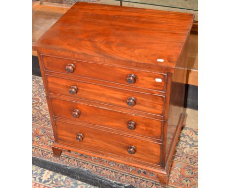 A Victorian commode, the front moulded to simulate a chest, splayed bracket feet.