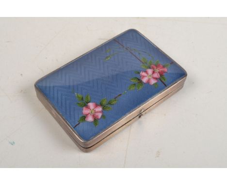 An American silver rectangular compact, the lid enamelled with a blossoming trellis on guilloche ground. Inside compartments 