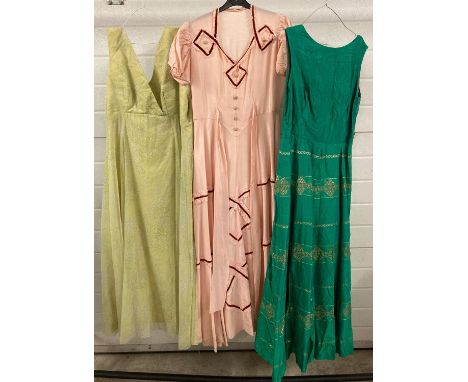 3 vintage full length evening dresses. To include 1940's style pink dress and a 1960's green dress with gold thread detail. 