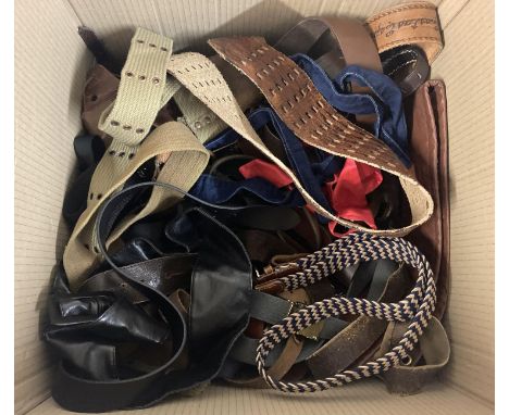 A large box of assorted mostly vintage belts to include leather examples. 