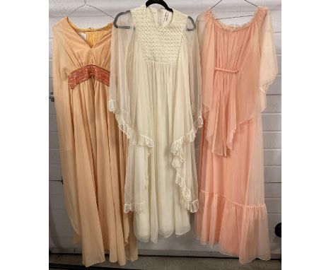 3 vintage 1970's chiffon angel sleeved maxi dresses in peach and cream colours. To include Peterson Maid of London. 