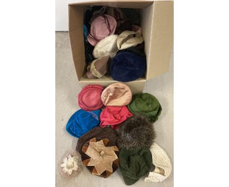 A large box of assorted vintage hats in varying styles and colours. 