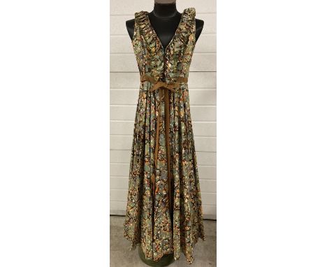 A vintage 1970's Jean Veron sleeveless full length evening dress. In psychedelic bubble pattern, satin material with frill de