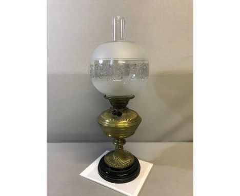 Victorian Ornate brass base paraffin lamp with ornate glass shade. 