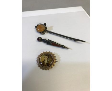 Yellow metal swivel brooch depicting Robert Burns portrait and house picture. Together with Sterling, Birmingham silver brooc