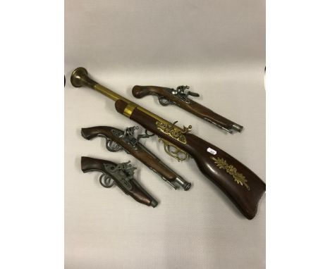 A collection of replica flintlock pistols and boom stick 