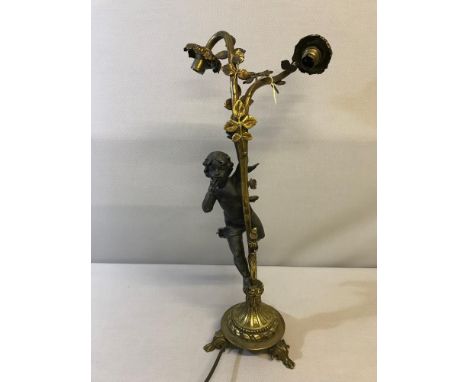 A Large Spelter cherub and gilt foliage design table lamp. Measures 57cm in height 