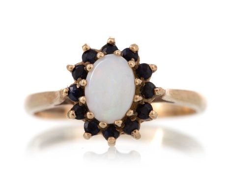 OPAL AND SAPPHIRE RING set with central oval within a halo of sapphires, in nine carat gold, size M 1/2Qty: 2g