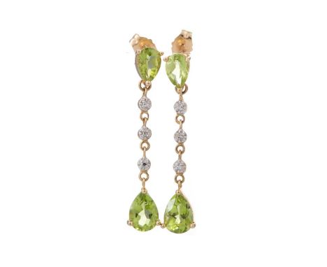 PAIR OF PERIDOT AND DIAMOND EARRINGS formed by pearl shaped peridots interspaced by diamond chips, marked 14K