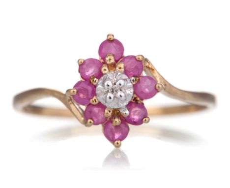RUBY AND DIAMOND RING set with round rubies and a central diamond chip, marked 375, size M 1/2Qty: 1.2g