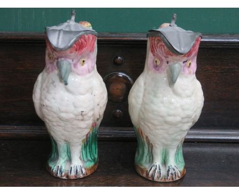 PAIR OF MAJOLICA STYLE PEWTER LIDDED CERAMIC PARROT JUGS 